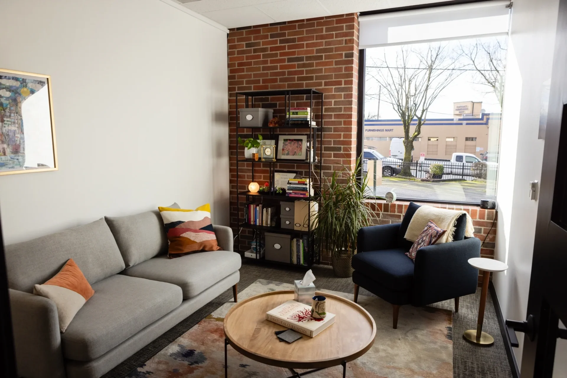 A living room with a couch, chair and table.