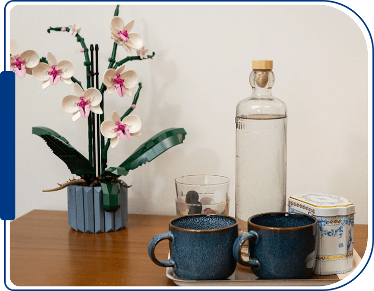 A table with two cups and a bottle